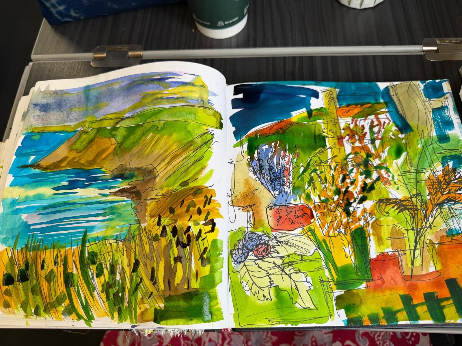 Open sketchbook filled with vivid blue, green, yellow and coral studies